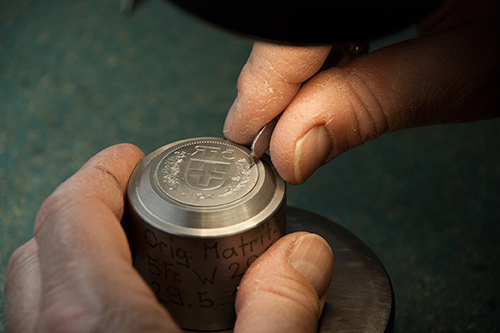 Finishing touches are applied by the engraver